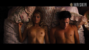 Lovely and sexy Margot Robbie flashes tits while doing some kind of bed scenes