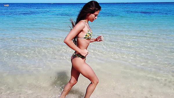 Raven haired slender beauty loves luring all the people on the beach