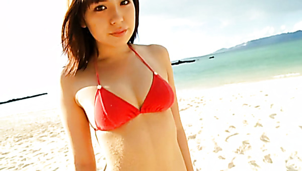 Cheesecake Japanese cutie twirls on the sand wearing tempting bikini
