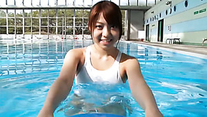 Chunky Japanese teen swims in a pool in white bikini