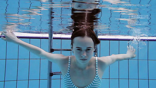 Slim redhead sweetie Anna Netrebko swims naked under water