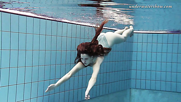 Slim girl Salaka Ribkina swimming in the pool all naked