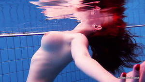Cute naked red haired teen swimming