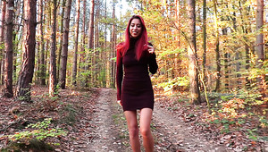 Sexy bright babe with bright red hair strips and flashes tits in the woods