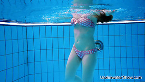 Lovely swimming bikini hottie Simonna stripteases underwater and exposes bum
